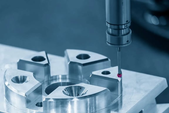 Probe of a coordinate measuring machine measures metallic precision part with holes